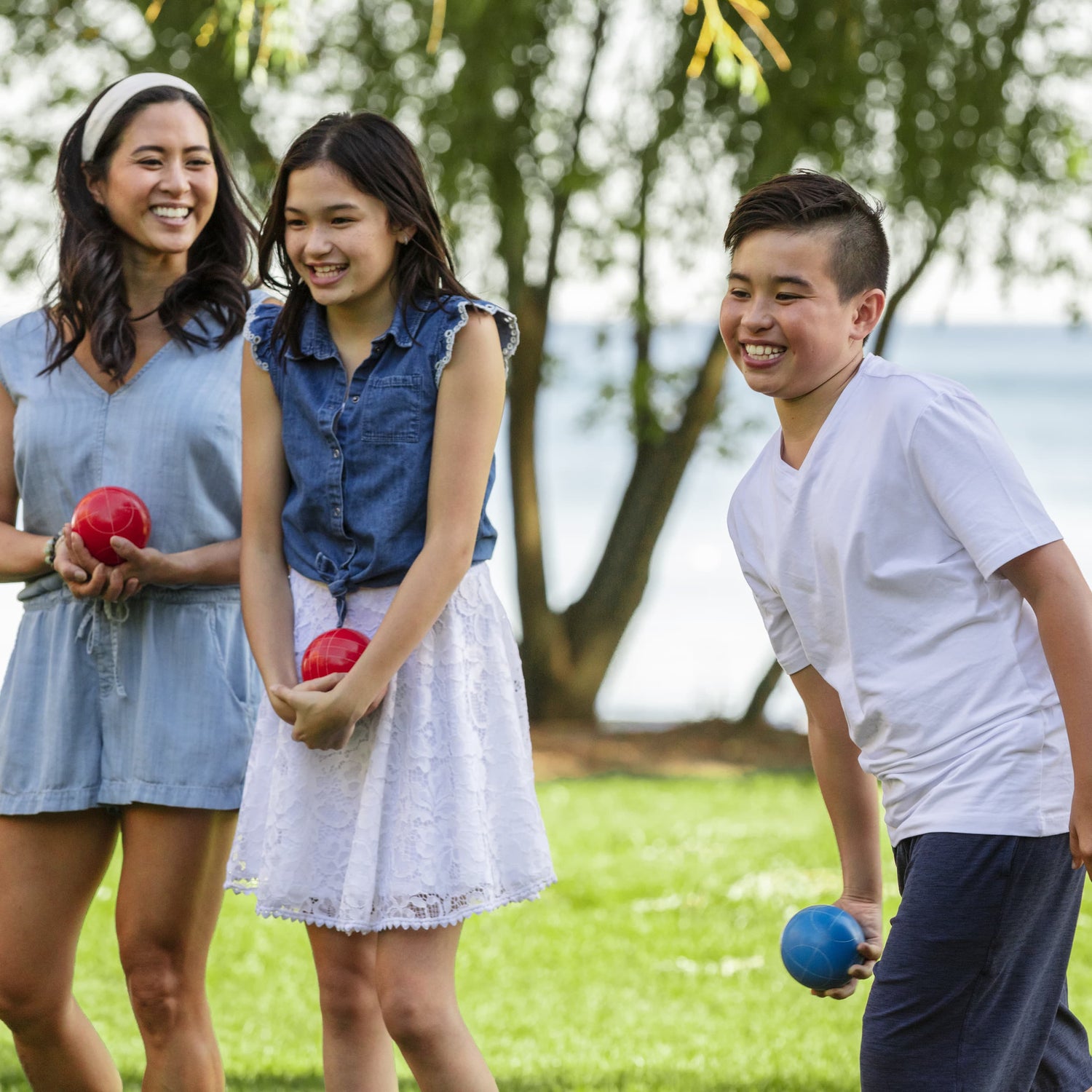 Sportcraft Bocce Ball Set Lifestyle Image, Family playing Bocce Ball in a park, boy throwing ball