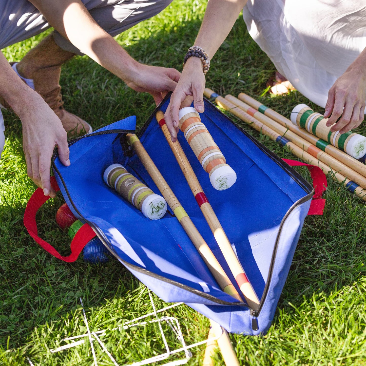 Sportcraft Croquet Set Lifestyle Image, Man & Woman putting Croquet Set in storage bag