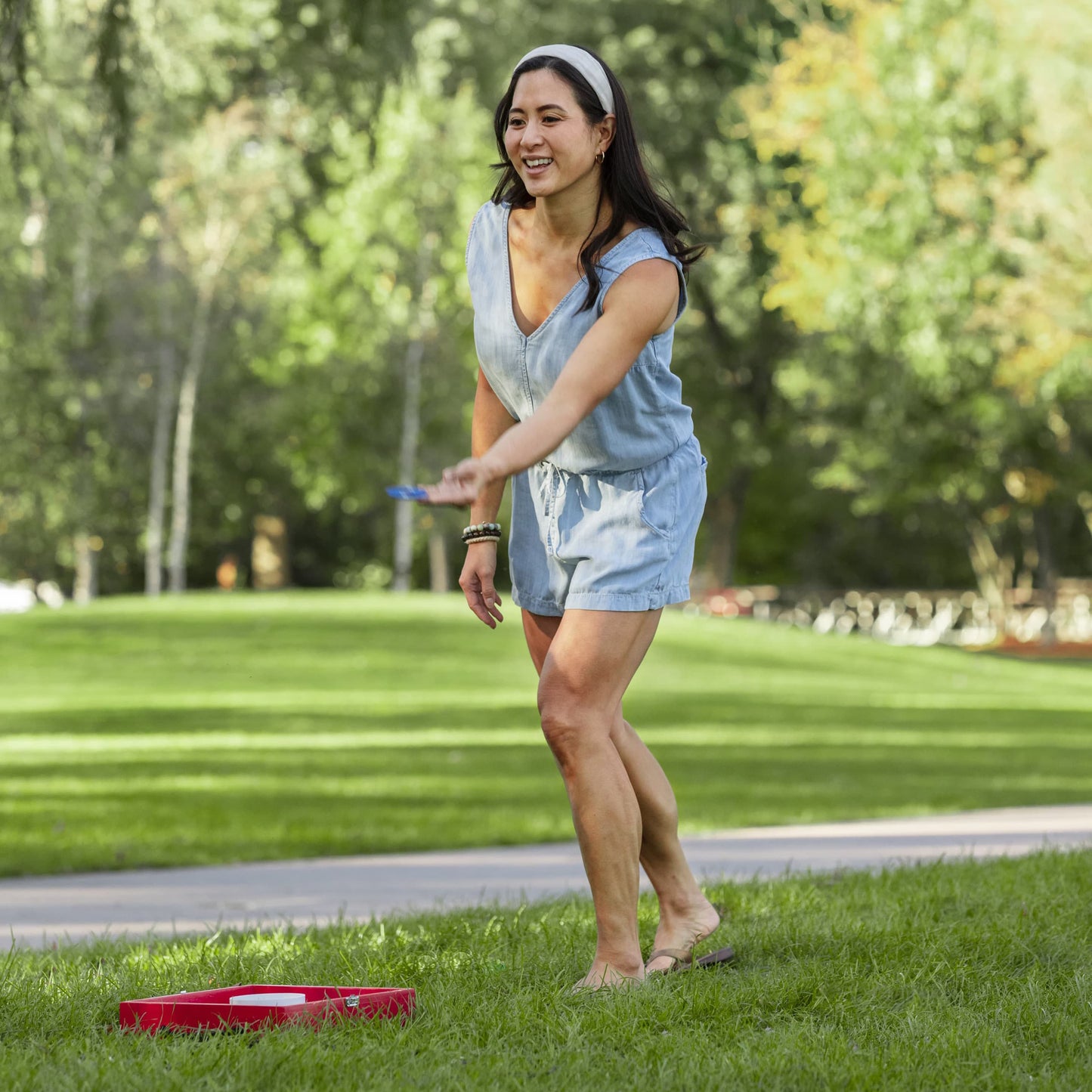 Sportcraft Wooden Washer Toss Game - Lifestyle Image - Woman Playing Game