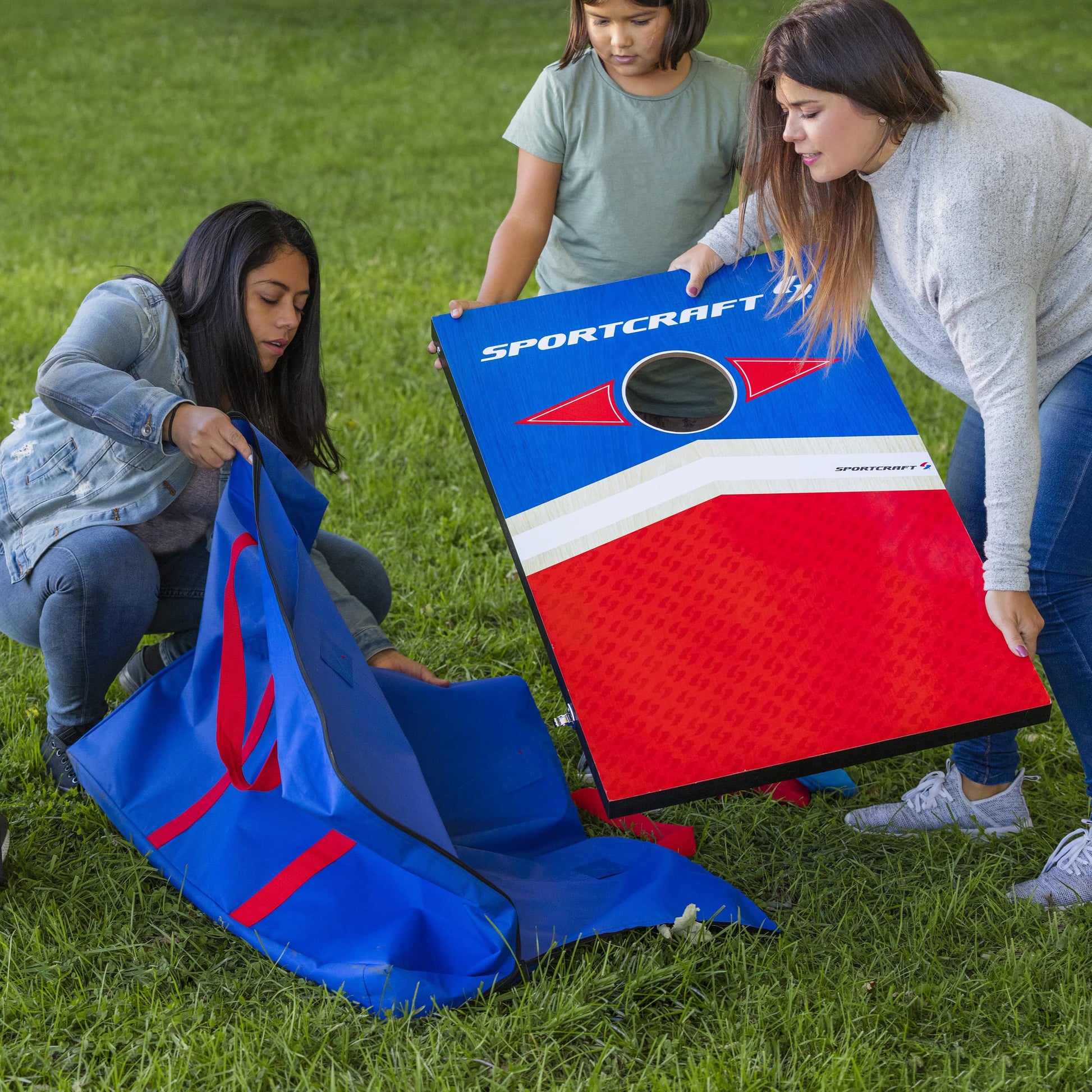 Sportcraft Wooden Corn Hole Bean Bag Toss Lifestyle Image, Family putting boards into storage bag