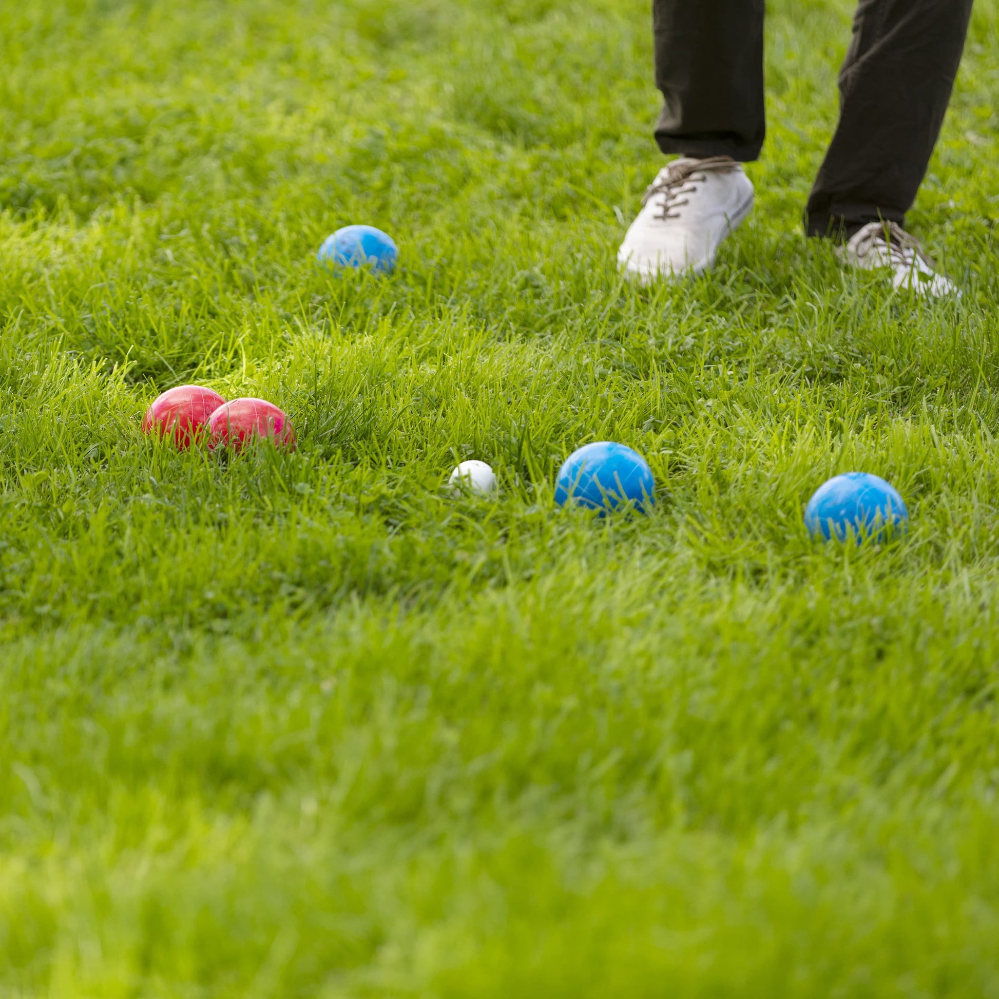 Sportcraft Bocce Ball Set Lifestyle Image, Men playing Bocce Ball in a park, closeup of balls on grass