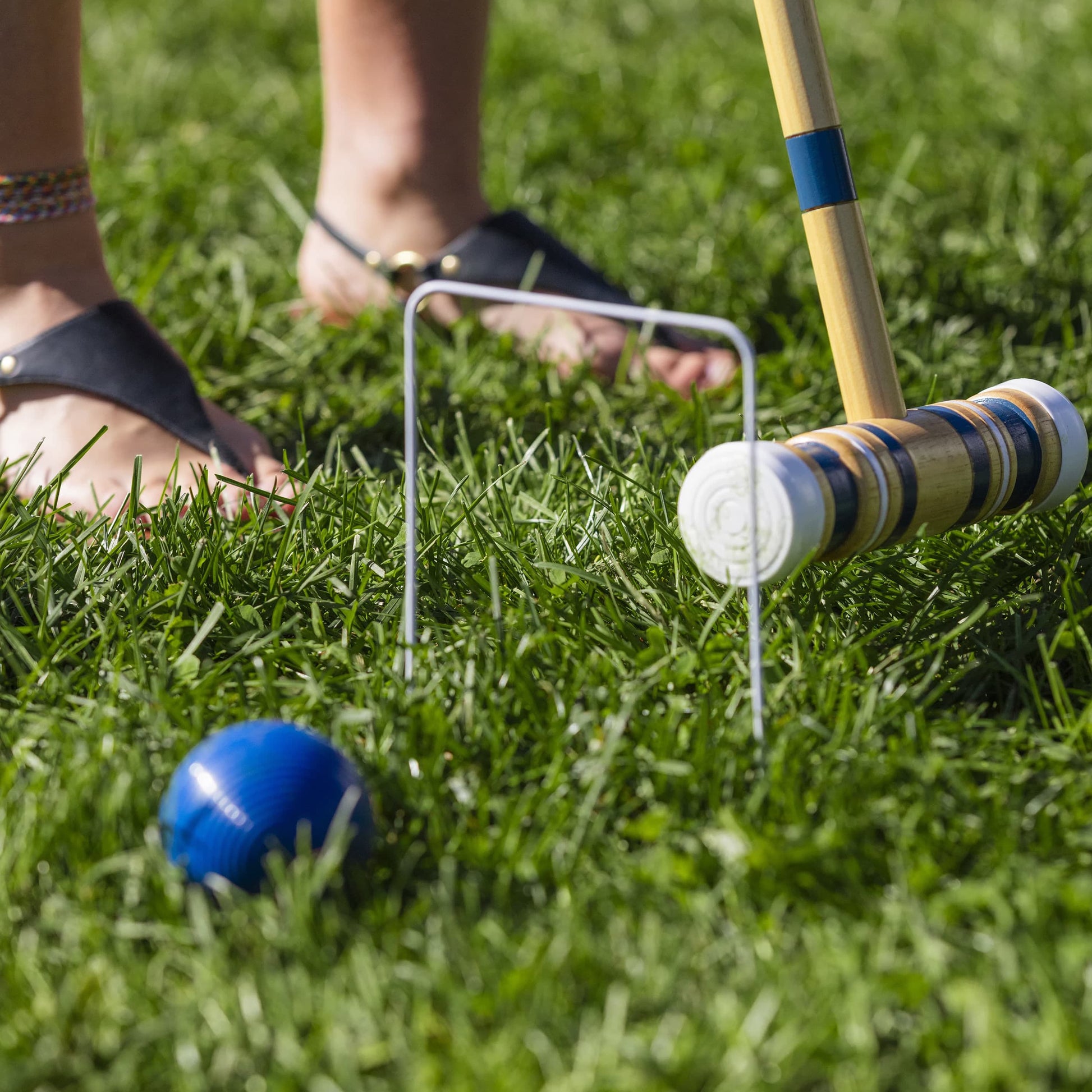 Sportcraft Croquet Set Lifestyle Image, Woman playing Croquet in a park, closeup of ball on grass