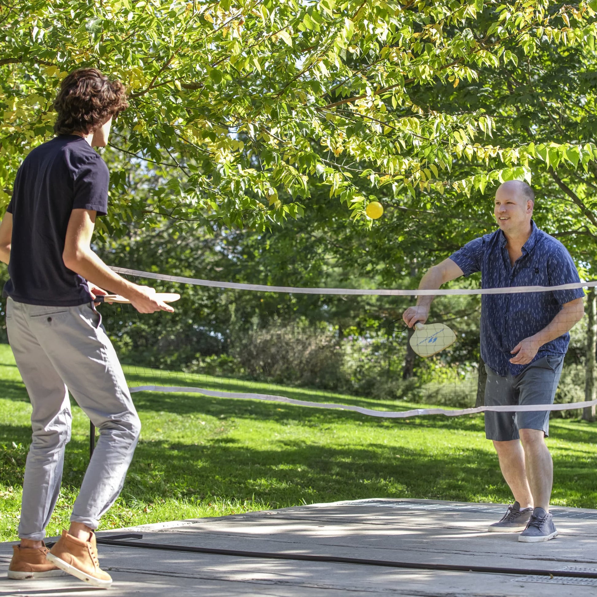Sportcraft PickleBall Set - Lifestyle Image - Father & Son playing PickleBall outside in park