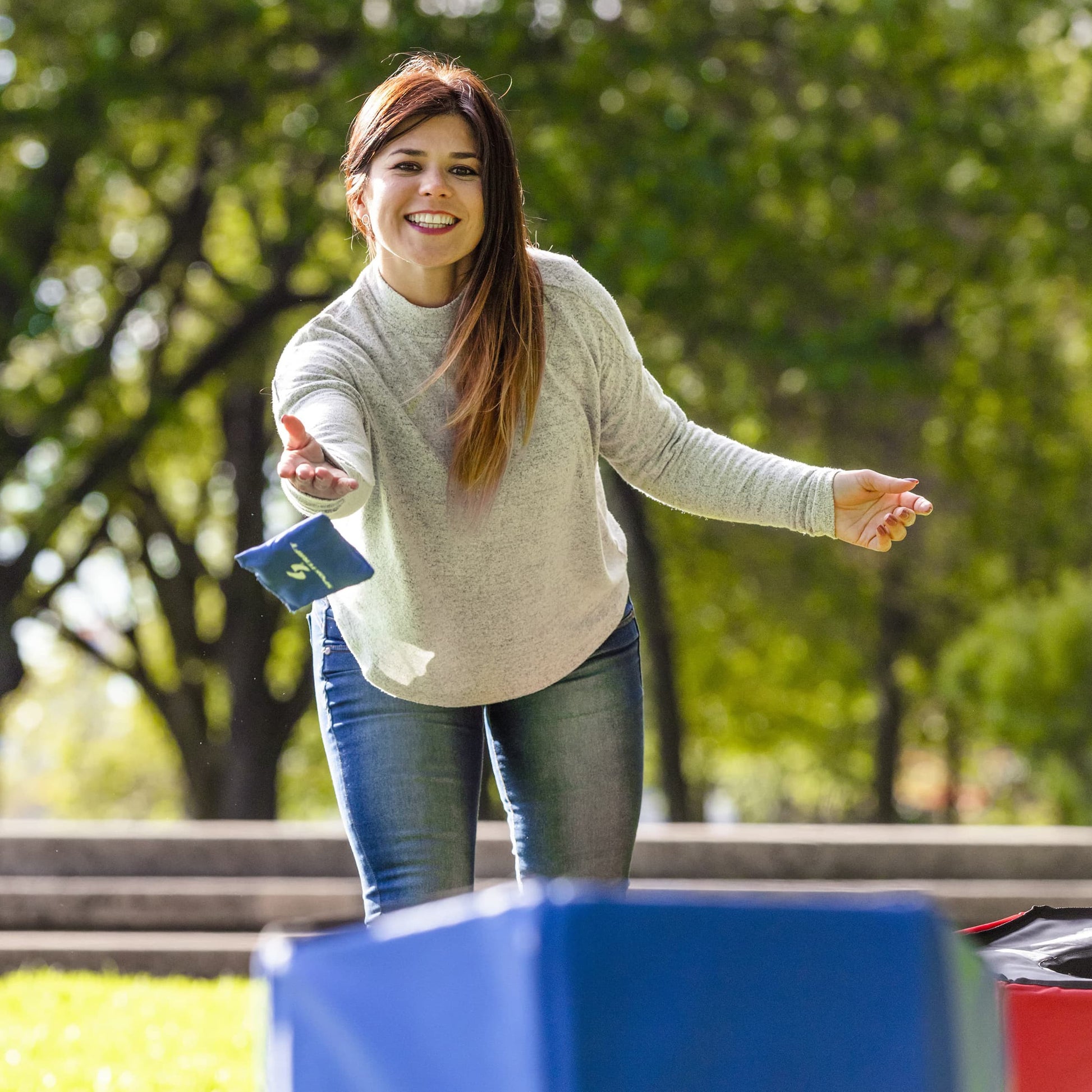 Sportcraft 2-In-1 Folding Disc Slam And Bean Bag Toss Game - Lifestyle Image - Woman throwing Bean Bag at target