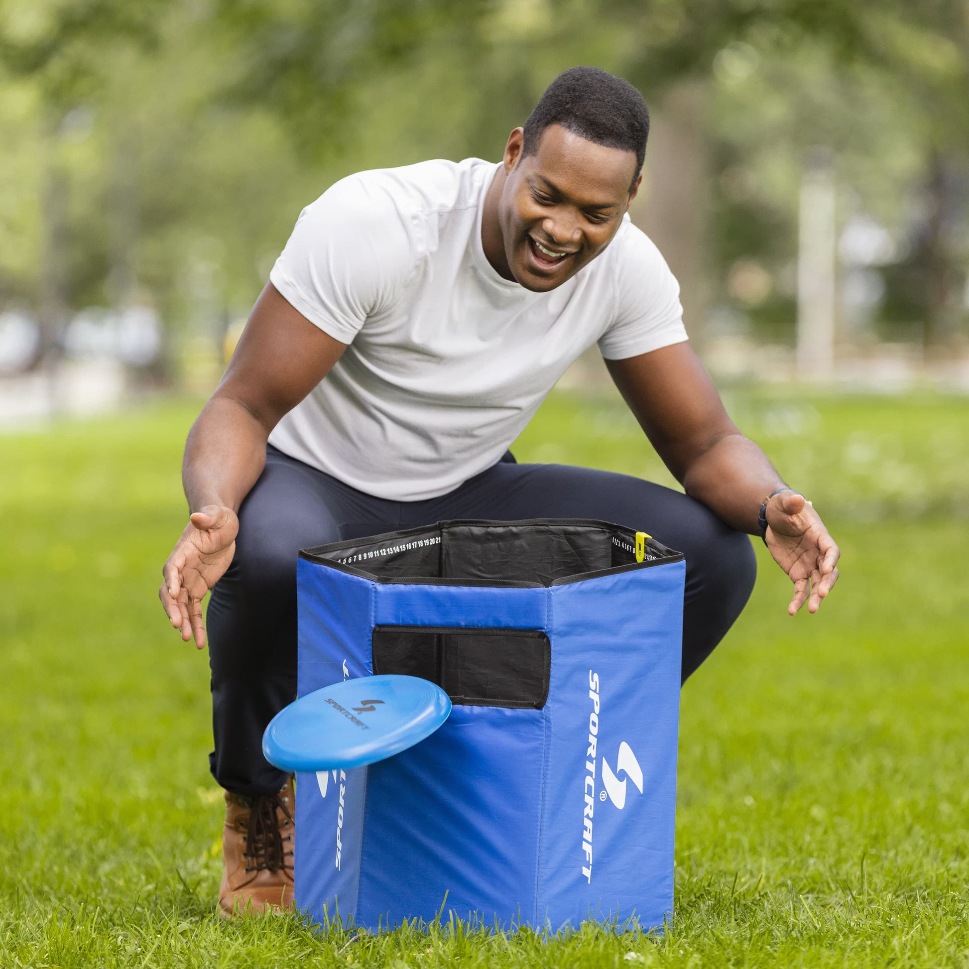 Sportcraft 2-In-1 Folding Disc Slam And Bean Bag Toss Game - Lifestyle Image - Man watch flying disc score on target